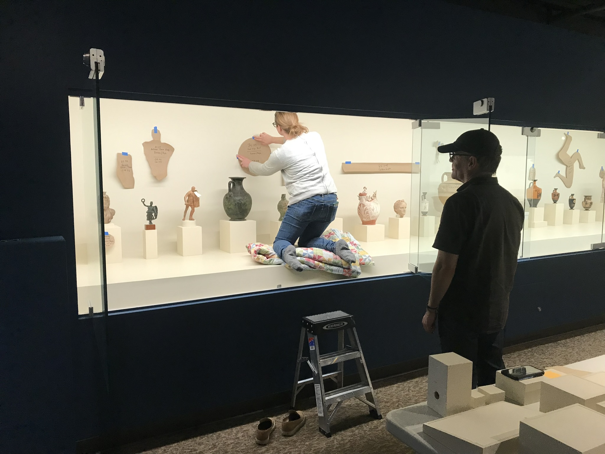 Museum Registrar and Collections Manager Sarah Thomson and Curator of Antiquities Benton Kidd work to reinstall objects.