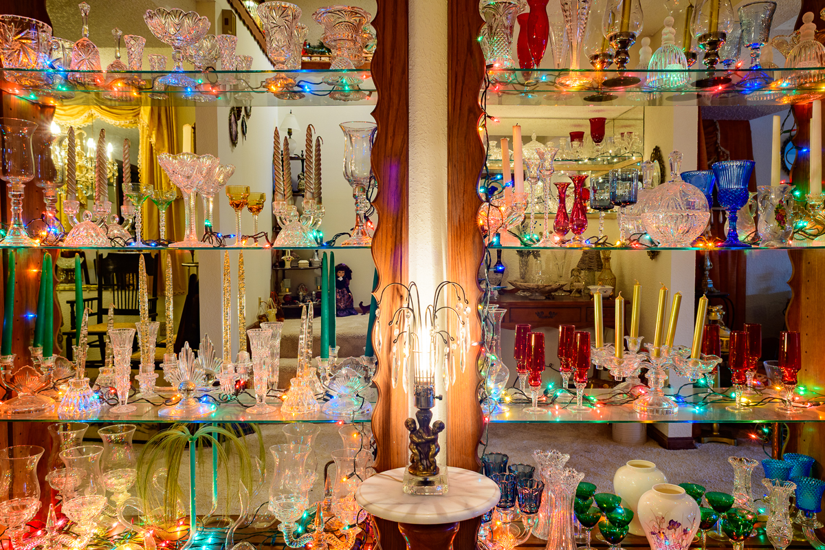 glass shelves lined with colorful glass bottles of various sizes and shapes