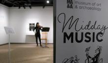 midday music banner with girl playing violin in the background